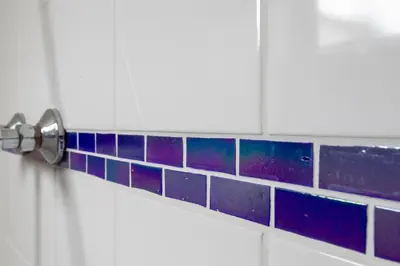 a bathroom with purple and blue tile on the wall at Centre beach lodge in Zandvoort