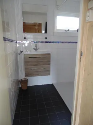 a bathroom with a sink and a toilet and a tub at Centre beach lodge in Zandvoort