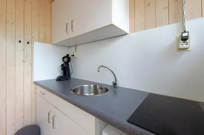 a kitchen with a sink and a counter top at Centre beach lodge in Zandvoort