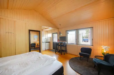 a bedroom with a bed and a table and chairs at Centre beach lodge in Zandvoort