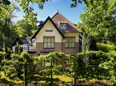 a house in the middle of a yard with trees at Villa 1913 in Bergen