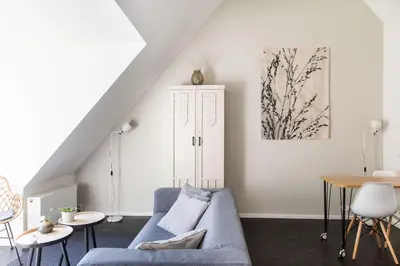 a living room with a blue couch and a table at Villa 1913 in Bergen