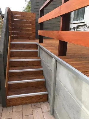 a set of wooden stairs on a balcony at Chalet Duinpan in IJmuiden
