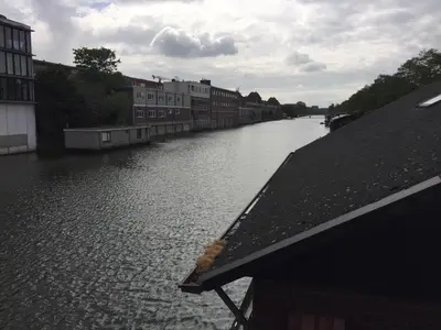 a river with buildings on the side of it at Reiwa in Amsterdam