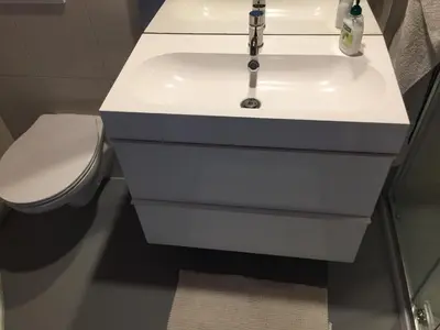 a bathroom with a white sink and a toilet at Reiwa in Amsterdam