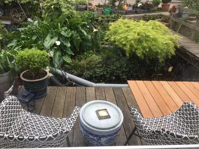 a view of a garden with a table and chairs at Reiwa in Amsterdam