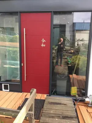 a red door on the front of a house at Reiwa in Amsterdam