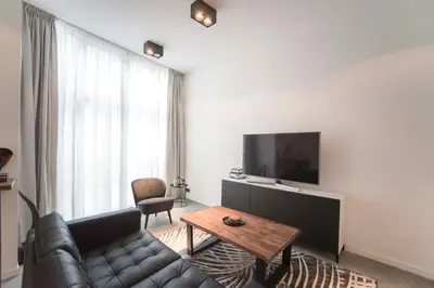 a living room with a couch and a table at Sack-Time fashion boutique hotel in Zandvoort