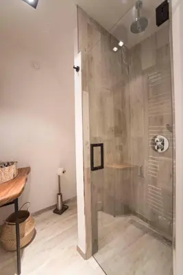 a shower with a glass door in a bathroom at Sack-Time fashion boutique hotel in Zandvoort