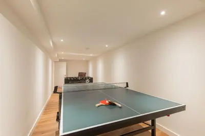 a ping pong table in the middle of a room at Lage Wurft Beach Apartments in Noordwijk