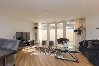 a living room with a zebra rug on the floor at Lage Wurft Beach Apartments in Noordwijk
