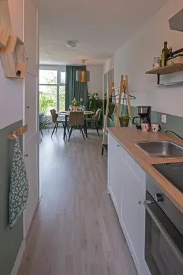 a kitchen and dining room with a dining table at Amsterdam Beach Apartment 65 in Zandvoort