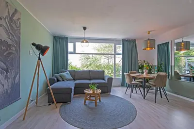 a living room with a couch and a table at Amsterdam Beach Apartment 65 in Zandvoort
