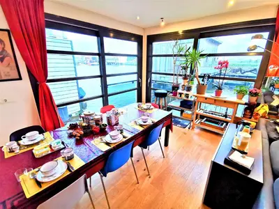 a dining room with a table and a large window at La Corte Sconta B&B in Amsterdam