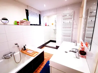 a white bathroom with two sinks and a mirror at La Corte Sconta B&B in Amsterdam