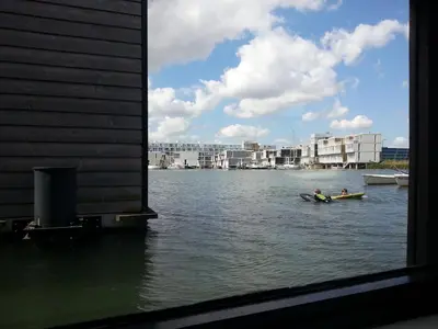 two people in a boat on a body of water at La Corte Sconta B&B in Amsterdam