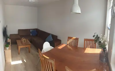 a living room with a table and a couch at Egmont op zee in Egmond aan Zee