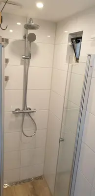 a shower with a glass door in a bathroom at Egmont op zee in Egmond aan Zee