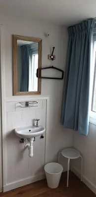 a bathroom with a sink and a mirror at Egmont op zee in Egmond aan Zee
