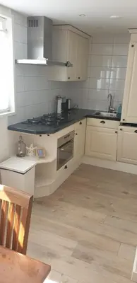 a kitchen with a sink and a stove top oven at Egmont op zee in Egmond aan Zee