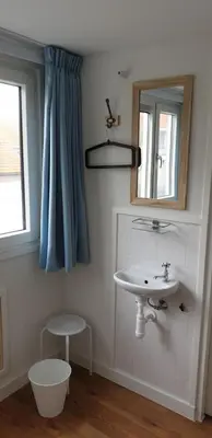a bathroom with a sink and a mirror at Egmont op zee in Egmond aan Zee