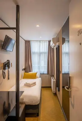 a hotel room with a bed and a window at Cityview Hotel in Amsterdam