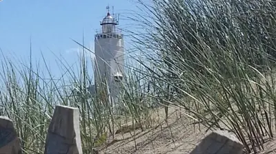 a lighthouse sitting on top of a sandy beach at Sous aan Zee in Noordwijk