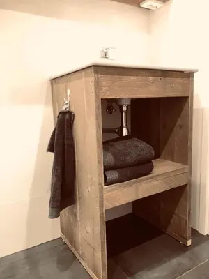 a wooden shelf in a bathroom with a sink at Sous aan Zee in Noordwijk