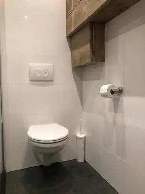 a bathroom with a white toilet in a room at Sous aan Zee in Noordwijk