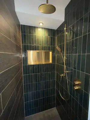 a green tiled bathroom with a shower and a sink at Spacious 70m2 apartment in city centre with lovely terrace in Alkmaar