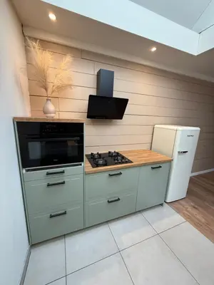 a kitchen with a stove and a refrigerator at Spacious 70m2 apartment in city centre with lovely terrace in Alkmaar