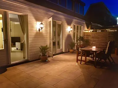 a patio with a table and chairs on a house at Spacious 70m2 apartment in city centre with lovely terrace in Alkmaar