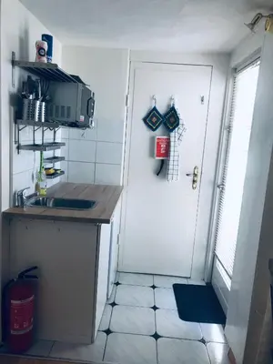 a kitchen with a sink and a white door at Casa Blanca Zandvoort in Zandvoort