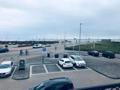 a bunch of cars parked in a parking lot at Casa Blanca Zandvoort in Zandvoort