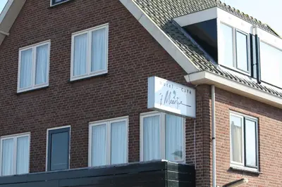 a brick building with a clock on the side of it at Hotel 't Meertje in Vinkeveen