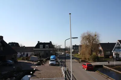 a street with cars parked in a residential neighbourhood at Hotel 't Meertje in Vinkeveen