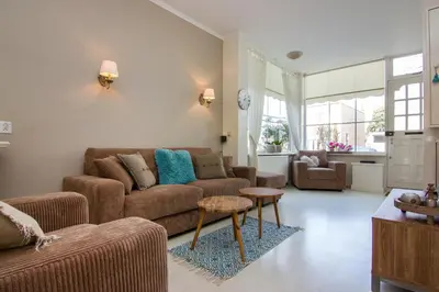a living room with a couch and a table at Happy Home in Zandvoort