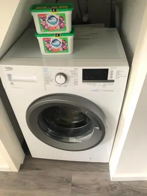a washing machine with two boxes on top of it at Poelgeeststraat in Leiden