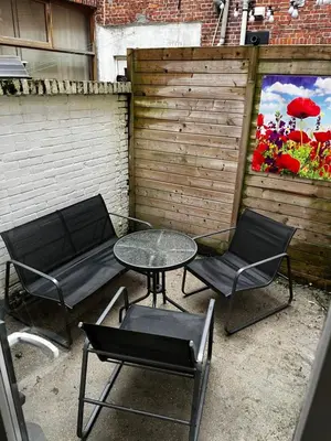 a patio with two chairs and a table and chairs at Poelgeeststraat in Leiden