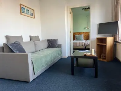 a living room with a couch and a table at Hotel Noordzee in Zandvoort