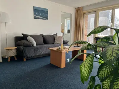 a living room with a couch and a coffee table at Hotel Noordzee in Zandvoort