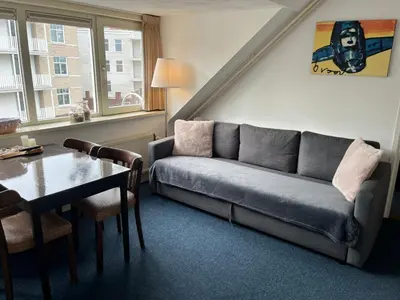 a living room with a couch and a table at Hotel Noordzee in Zandvoort