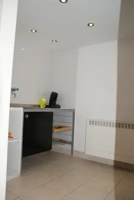 a kitchen with a counter and a desk in a room at Continentaiz Appartement in Zandvoort