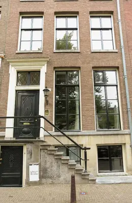 a brick building with stairs in front of it at EMPIRIC Keizersgracht in Amsterdam