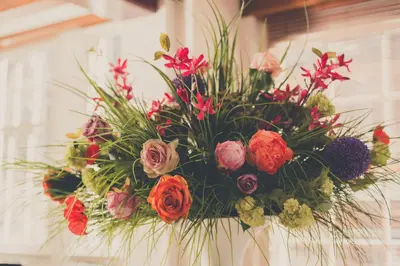 a bouquet of flowers is hanging on a wall at EMPIRIC Keizersgracht in Amsterdam