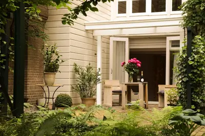a patio with potted plants on a house at EMPIRIC Keizersgracht in Amsterdam