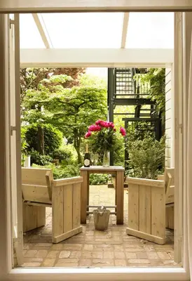 an open window with potted plants on a patio at EMPIRIC Keizersgracht in Amsterdam