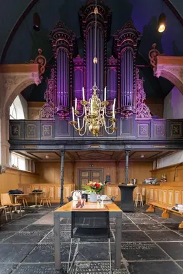 a large room with a large organ in a building at B&B Appartement Hemels in Twisk