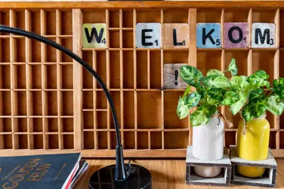 a desk with a lamp and a plant and letters at B&B Appartement Hemels in Twisk