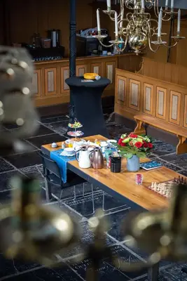a living room with a table and a stove at B&B Appartement Hemels in Twisk